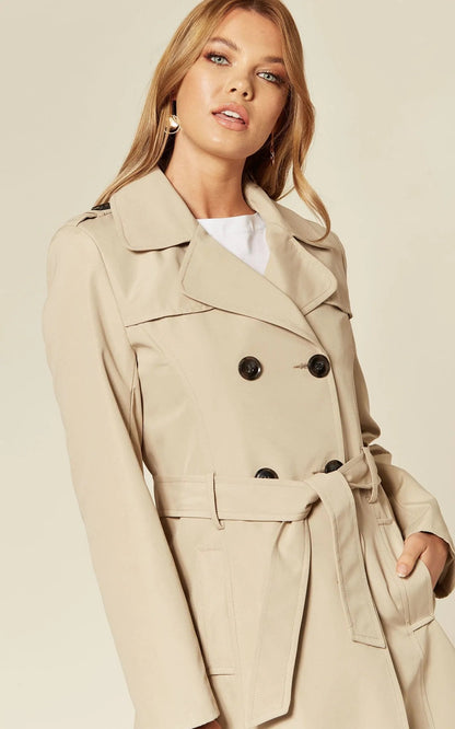 Rose Eleusis military-style double-breasted trench coat in spring/summer fabric, shown in a neutral stone color.