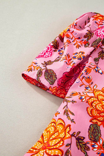 Pink floral bubble sleeve V-neck ruffled mini dress by Carmine Juneberry, featuring a stylish floral pattern and playful ruffle details.