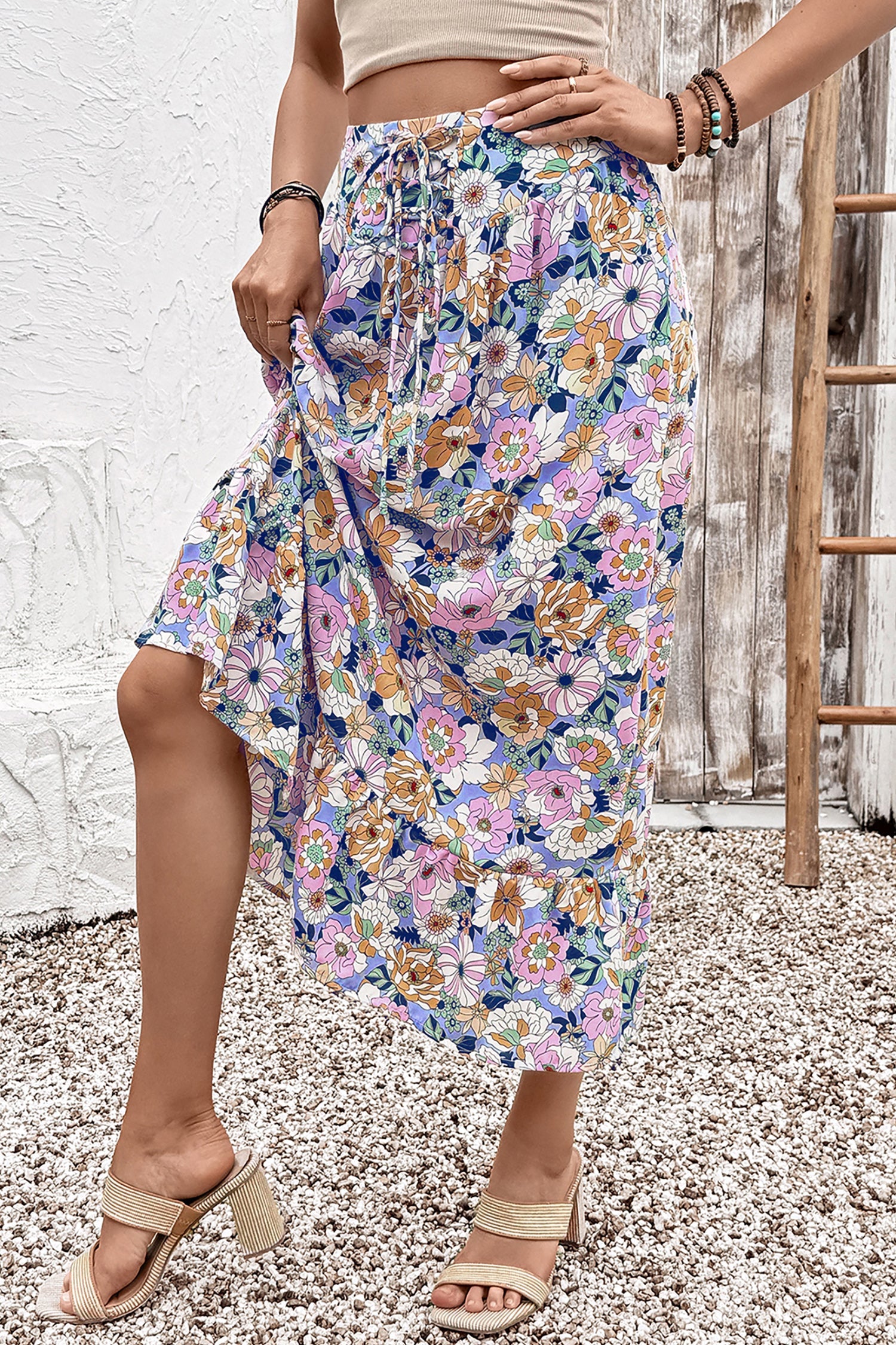 Floral lace-up high waist ruffle maxi skirt from Byzantium Bay, flowing fabric with floral pattern and ruffled hem for women.