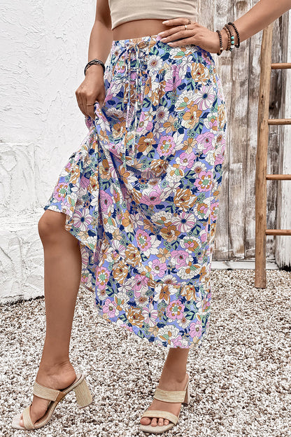Floral lace-up high waist ruffle maxi skirt from Byzantium Bay, flowing fabric with floral pattern and ruffled hem for women.