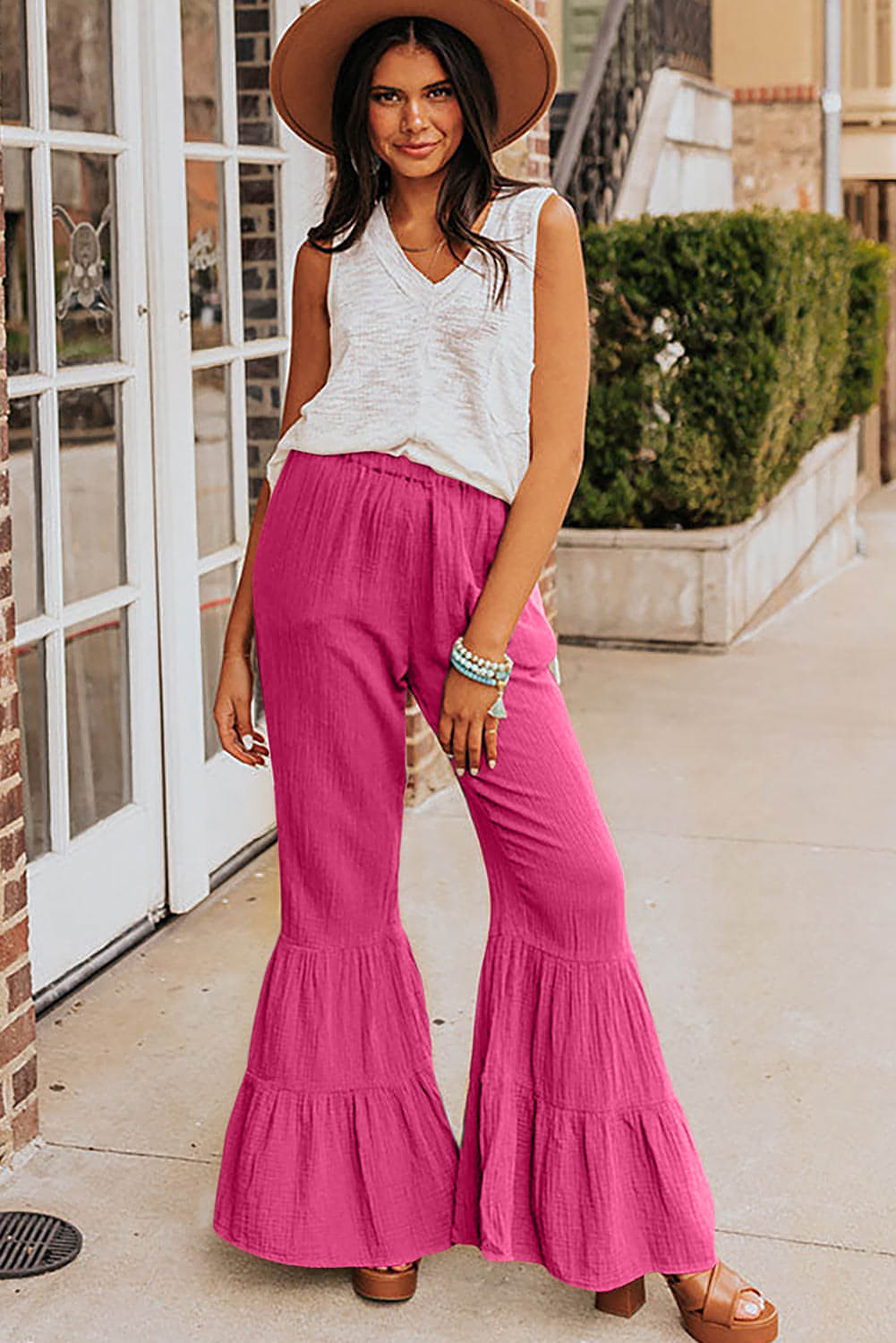Rose textured high waist ruffled bell bottom pants by Carmine Juneberry, showcasing floral fabric, high waist, and flared leg design.