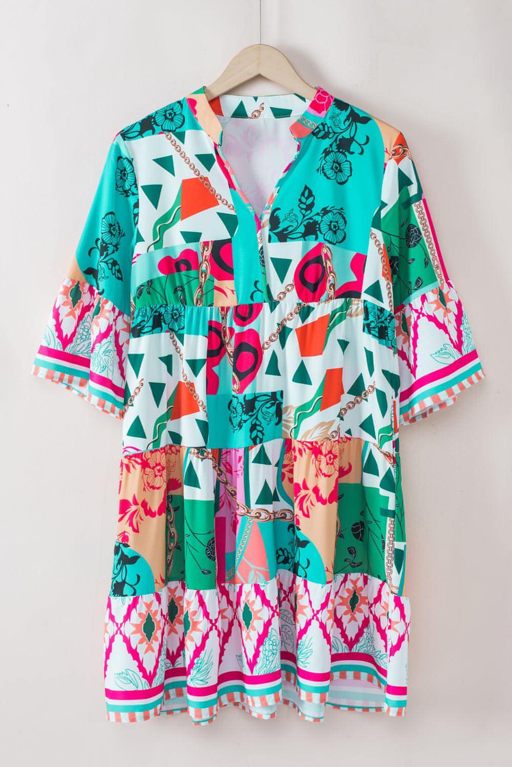 Multicolour abstract printed half sleeve mini dress with notched neckline by Carmine Juneberry, stylish and vibrant for casual wear.