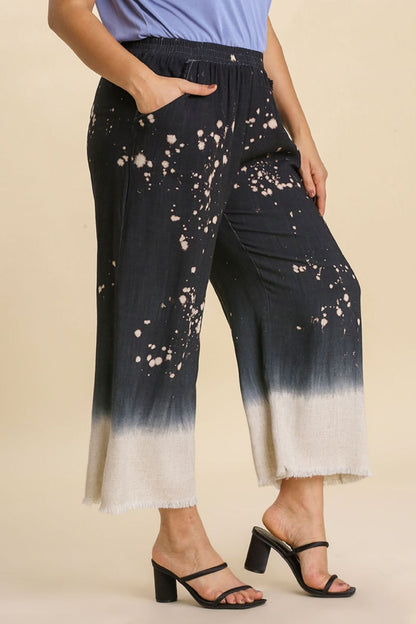 Jade Icarus Umgee wide-leg linen blend bleach dip dye pants with raw hem, full size, laid flat showing the colorful, distressed style.
