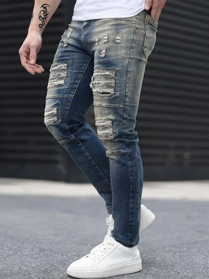 Men’s navy ripped stretch jeans by Carmine Juneberry, urban high street style, featuring distressed details and a slim fit.