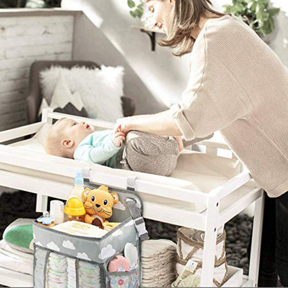 Maroon Asteria portable baby crib organizer hanging bag with multiple pockets for baby essentials on a crib.