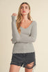 Jade Icarus Aemi + Co lettuce hem scoop neck long sleeve knit top, featuring a fitted design and lettuce-edged hem in soft fabric.