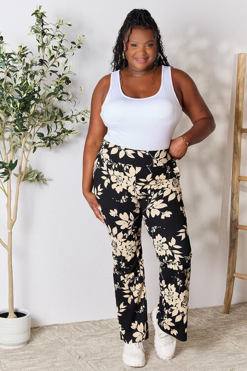 Jade Icarus Heidi Flare Pants in black, stylish high-waisted pants with flared legs, shown on a model against a neutral background.