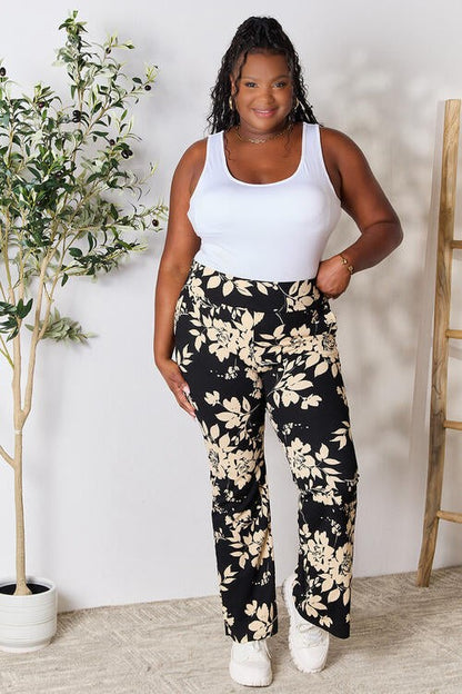 Jade Icarus Heidi Flare Pants in black, stylish high-waisted pants with flared legs, shown on a model against a neutral background.