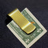 Brass money clip with sleek, polished finish, used as stylish home decor by Fuchsia Molly.