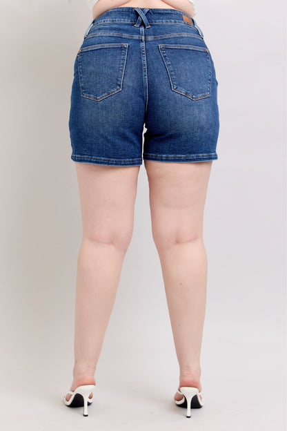 Judy Blue plus size denim shorts with double button waistband, styled for a casual look, featuring classic blue denim fabric.