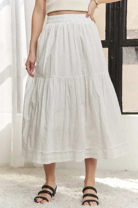 Jade Icarus ADORA elastic waistband tiered midi skirt with flowing fabric, displayed on a model showing its stylish design and movement.