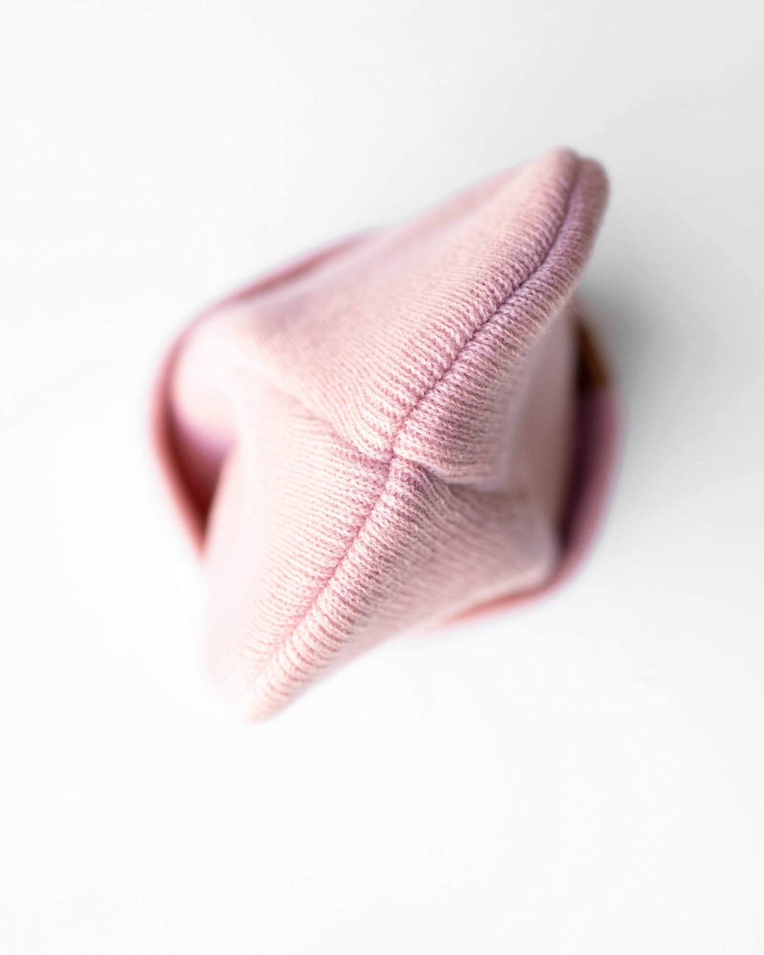 Azure Arrowwood HAAKWEAR knit cuffed beanie in pearl pink, soft textured hat with a cozy folded cuff.