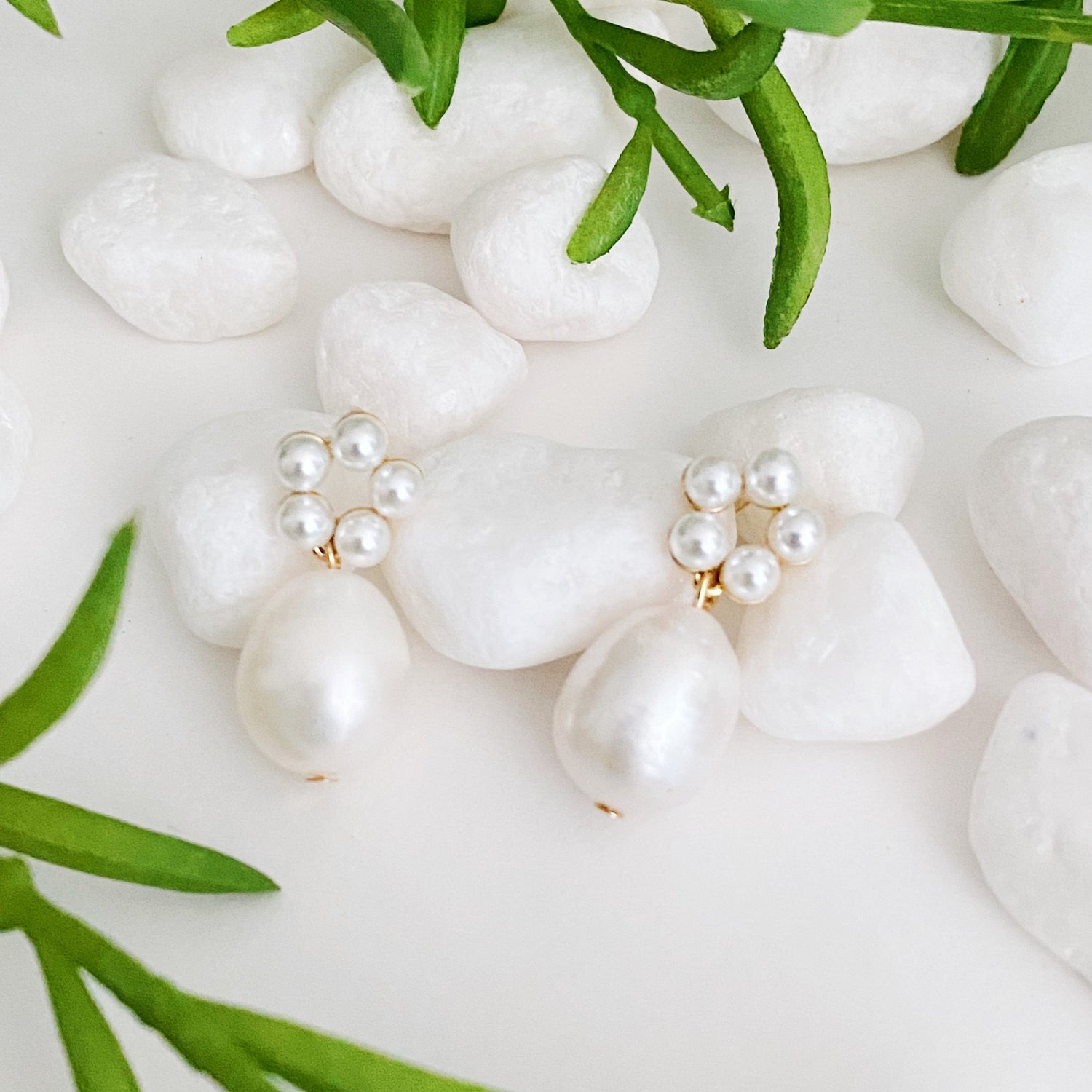 Fuchsia Hercules freshwater pearl drop earrings with elegant pearl drops and silver hooks on a white background