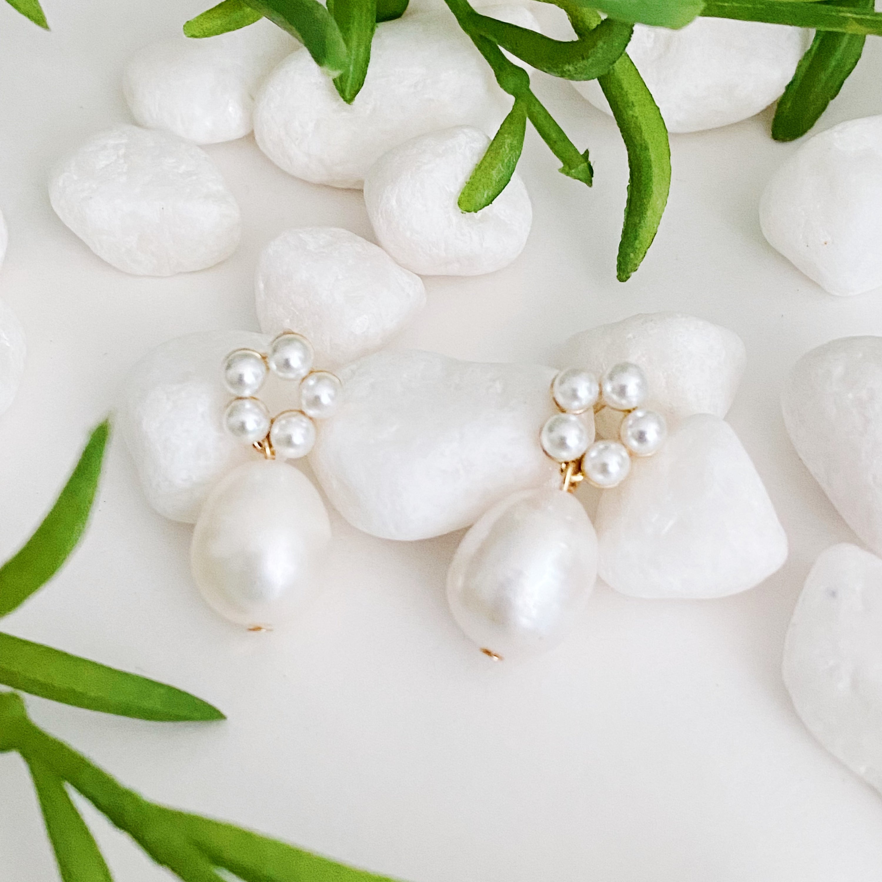 Fuchsia Hercules freshwater pearl drop earrings with elegant pearl drops and silver hooks on a white background