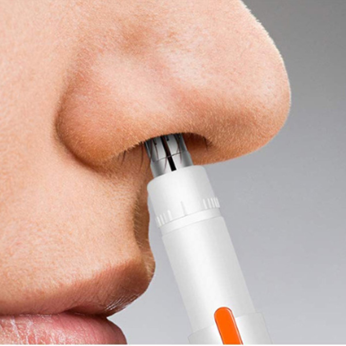 Salmon Lucky vanity hair trimmer for ears and nose, compact tech accessory with stainless steel blades and ergonomic design.