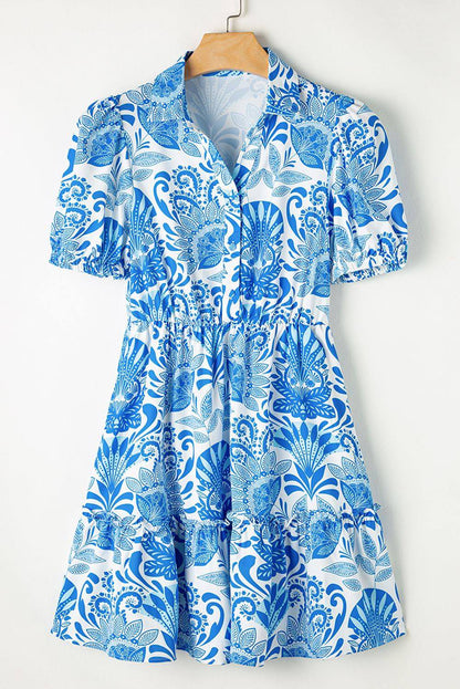 Sky blue retro floral print mini dress with ruffled hem and drawstring waist by Carmine Juneberry, perfect for summer.