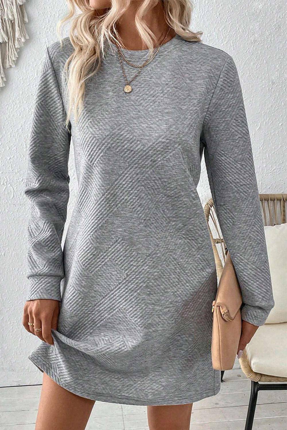 Gray solid color textured long sleeve shift dress by Carmine Juneberry, showcasing its simple, elegant design and fabric details.