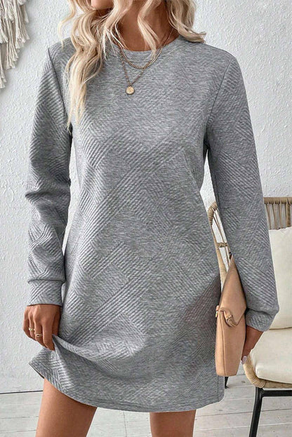 Gray solid color textured long sleeve shift dress by Carmine Juneberry, showcasing its simple, elegant design and fabric details.
