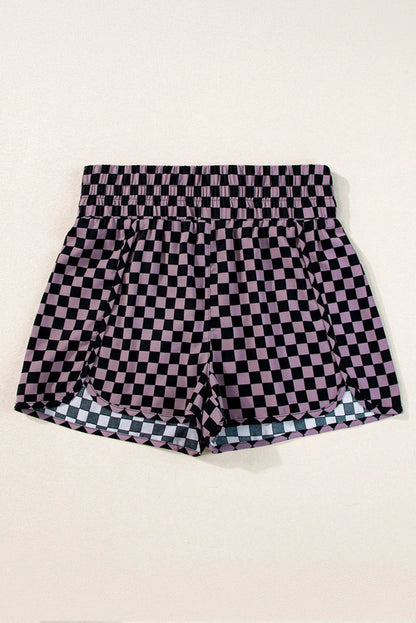 Byzantium Bay leopard and checker high waist athletic shorts displayed on a model, featuring bold print and comfortable fit.