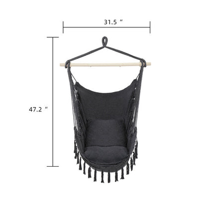 Gray boho hanging chair with fringe and cushions from Carmine Juneberry, showcasing comfortable furniture for relaxing indoor or outdoor spaces.