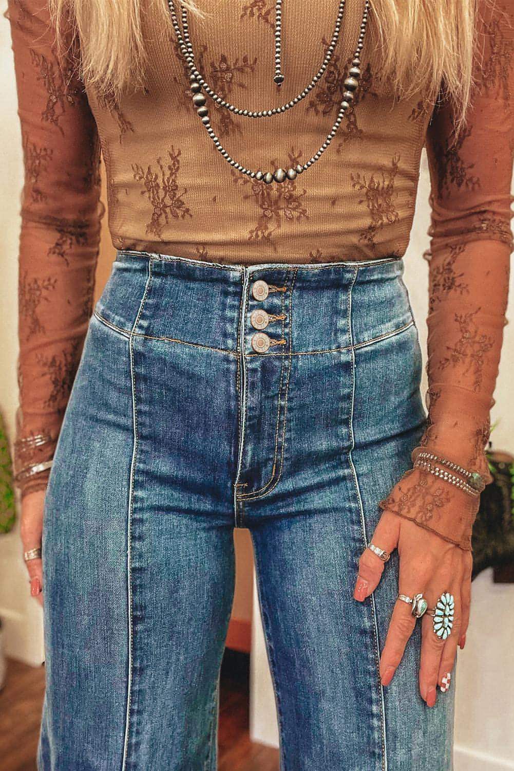 Sail blue high waist flare jeans by Carmine Juneberry featuring button fly, seamed details, and raw hem design.
