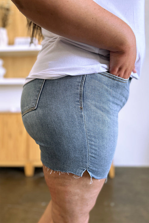 Judy Blue high waist raw hem denim shorts with distressed details, styled with a casual summer outfit.