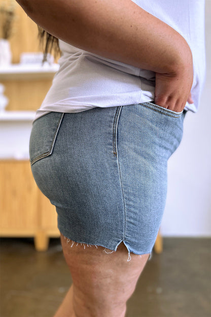 Judy Blue high waist raw hem denim shorts with distressed details, styled with a casual summer outfit.