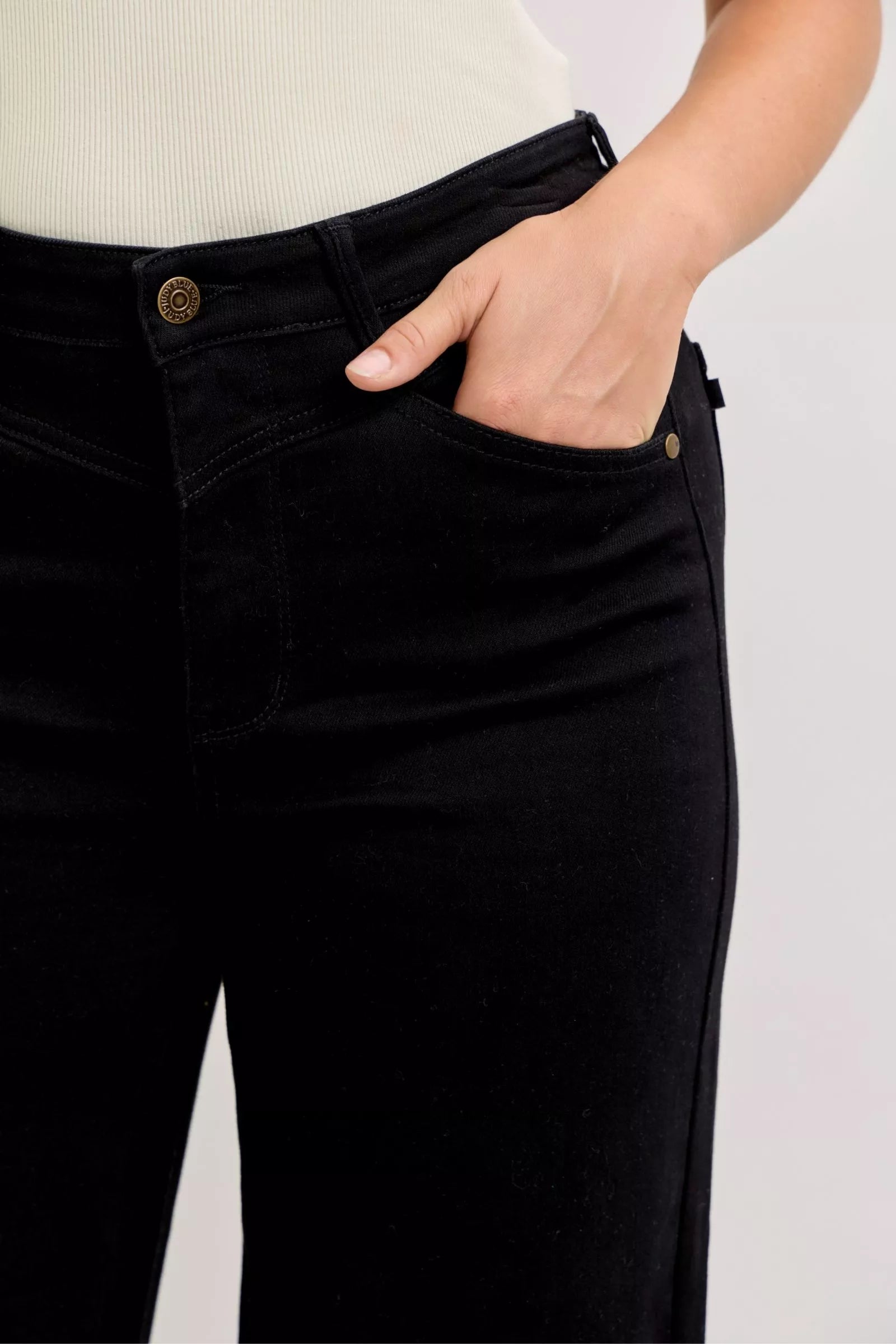 Pear Daisy Judy Blue high-waisted wide-leg jeans displayed on a hanger, showcasing the denim&