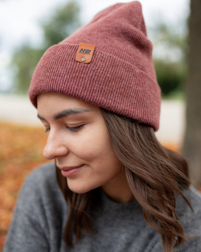 Azure Arrowwood HAAKWEAR knit cuffed beanie in rusty burgundy, featuring a cozy, textured knit pattern and a snug fit.
