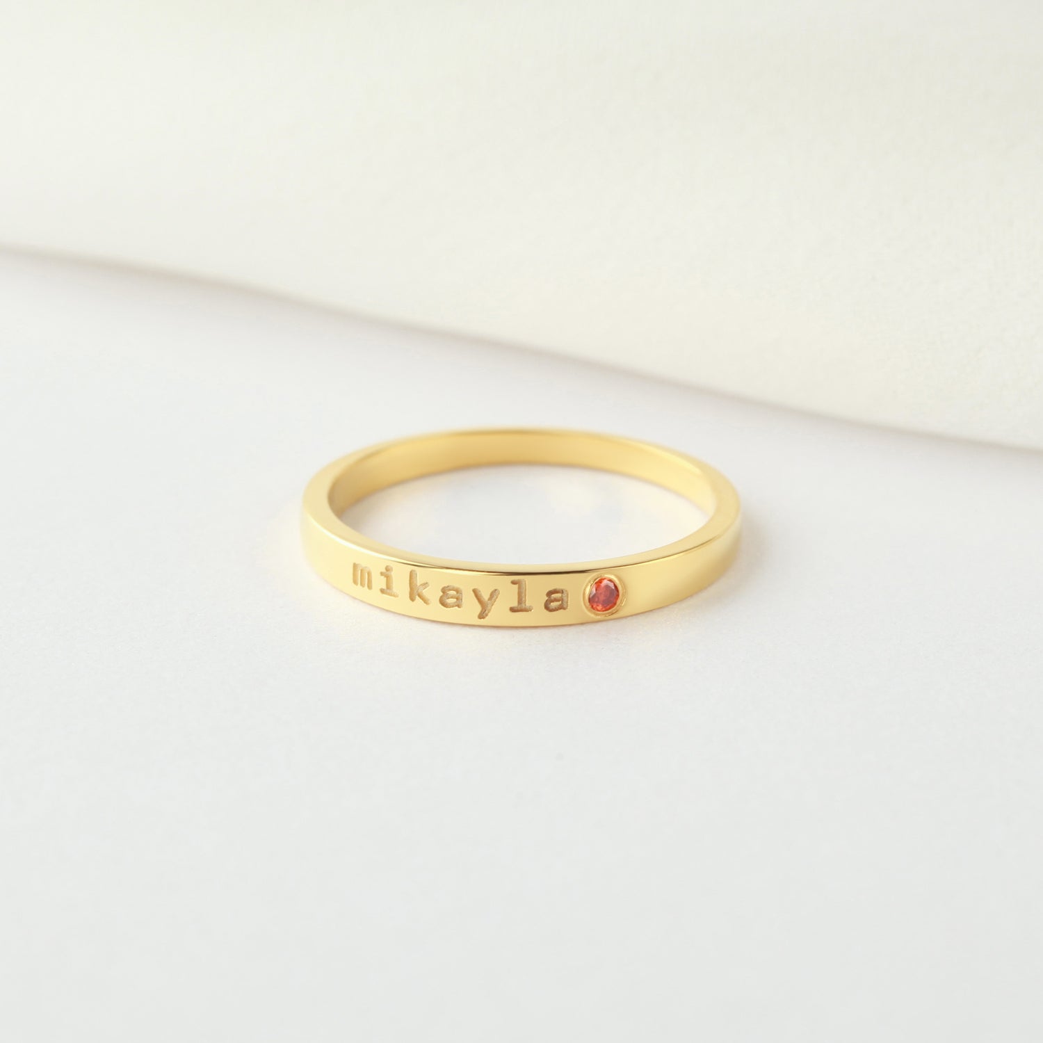 Personalized green millie name ring with birthstone, stackable mom ring featuring engraved name and gemstone accent.