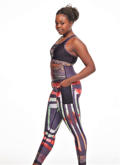 White Oliver Adyre on Brocade vibrant activewear leggings with side pocket, featuring bold patterns and comfortable stretch fabric.