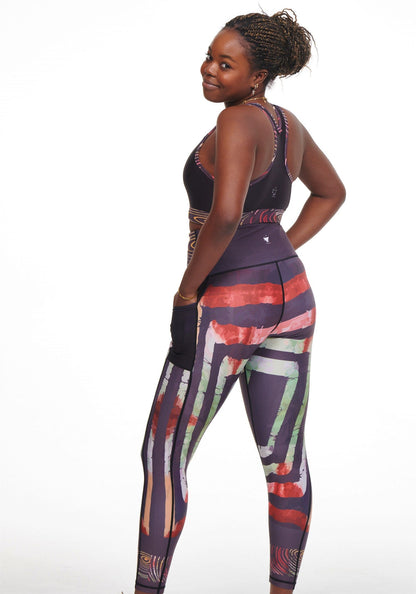 White Oliver Adyre vibrant leggings with side pockets, featuring colorful brocade design and stretchy activewear material.