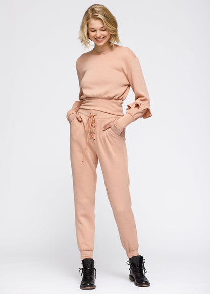 Lemon Hera peach crewneck sweatshirt with ruffle sleeve and peplum design, made of soft sweater material.