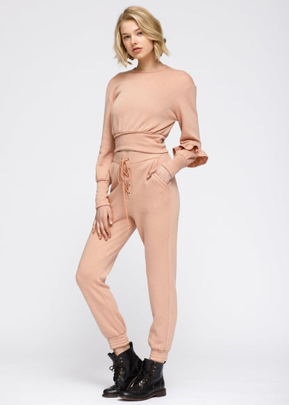 Lemon Hera peach crewneck sweatshirt with ruffle sleeves and peplum design, made of soft sweater fabric.