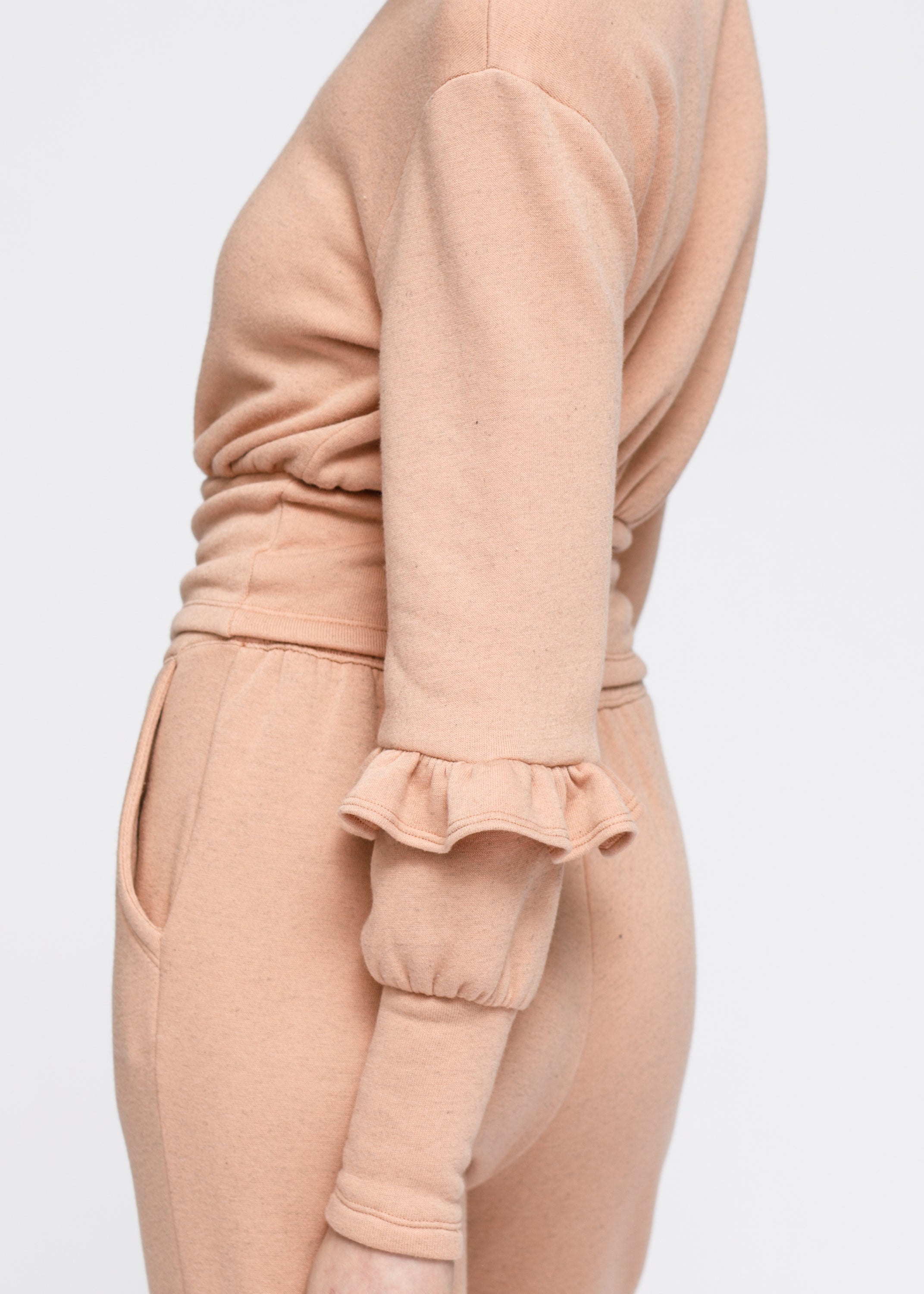 Lemon Hera peach crewneck sweatshirt with ruffle sleeves and peplum style, made from soft fabric, casual and stylish for women.