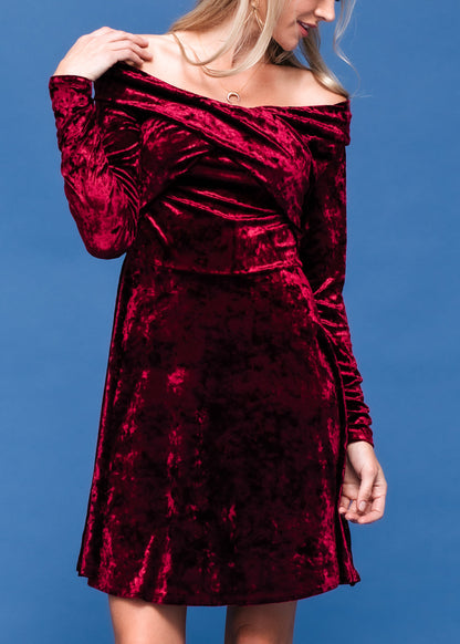 Burgundy velvet off-shoulder dress by Lemon Hera, featuring a fitted silhouette and elegant drape, displayed on a white background.