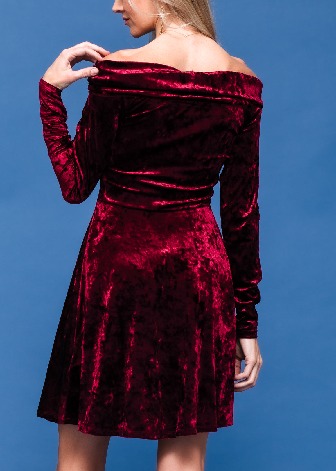 Burgundy velvet off-shoulder dress by Lemon Hera, featuring a stylish and elegant design with long sleeves and fitted silhouette.