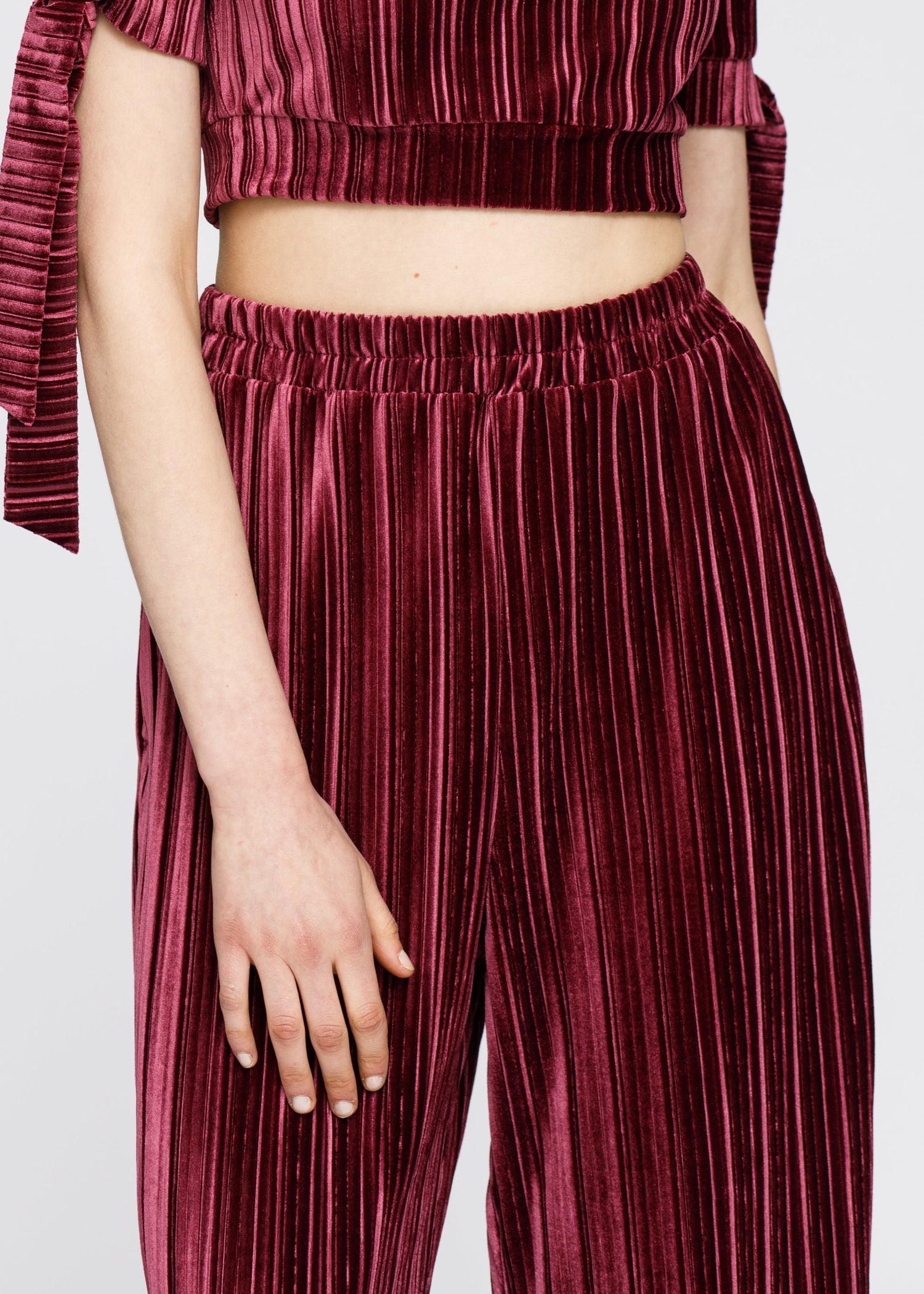 Women’s velvet wide leg high waist pants in mulberry color by Lemon Hera, showing the flowing fabric and high-rise fit.