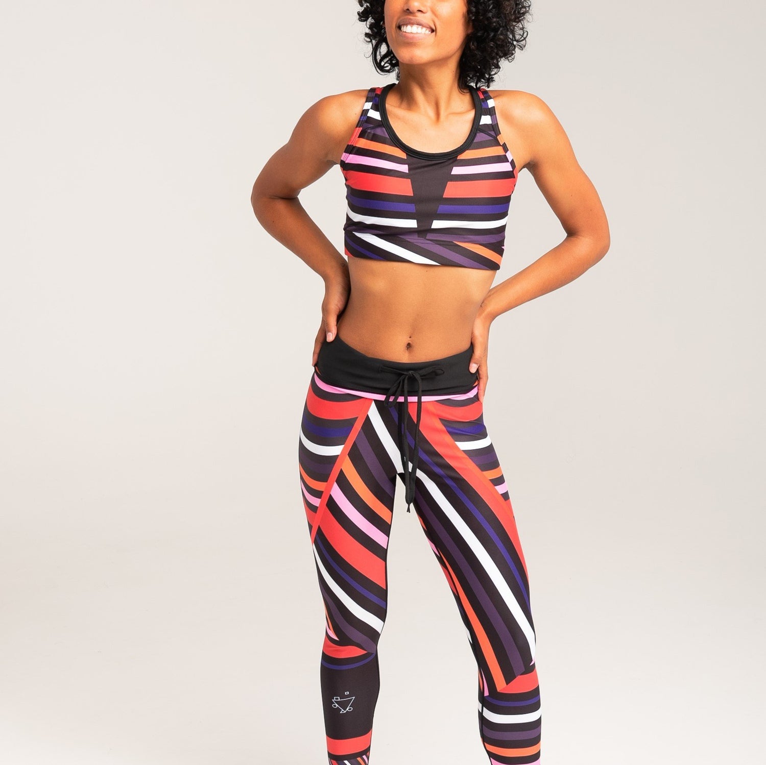 Vibrant Aso-Oke patterned leggings by White Oliver, activewear with colorful traditional African textile design.