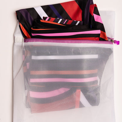 Vibrant Aso-Oke patterned leggings by White Oliver for activewear, featuring colorful traditional African fabric design.