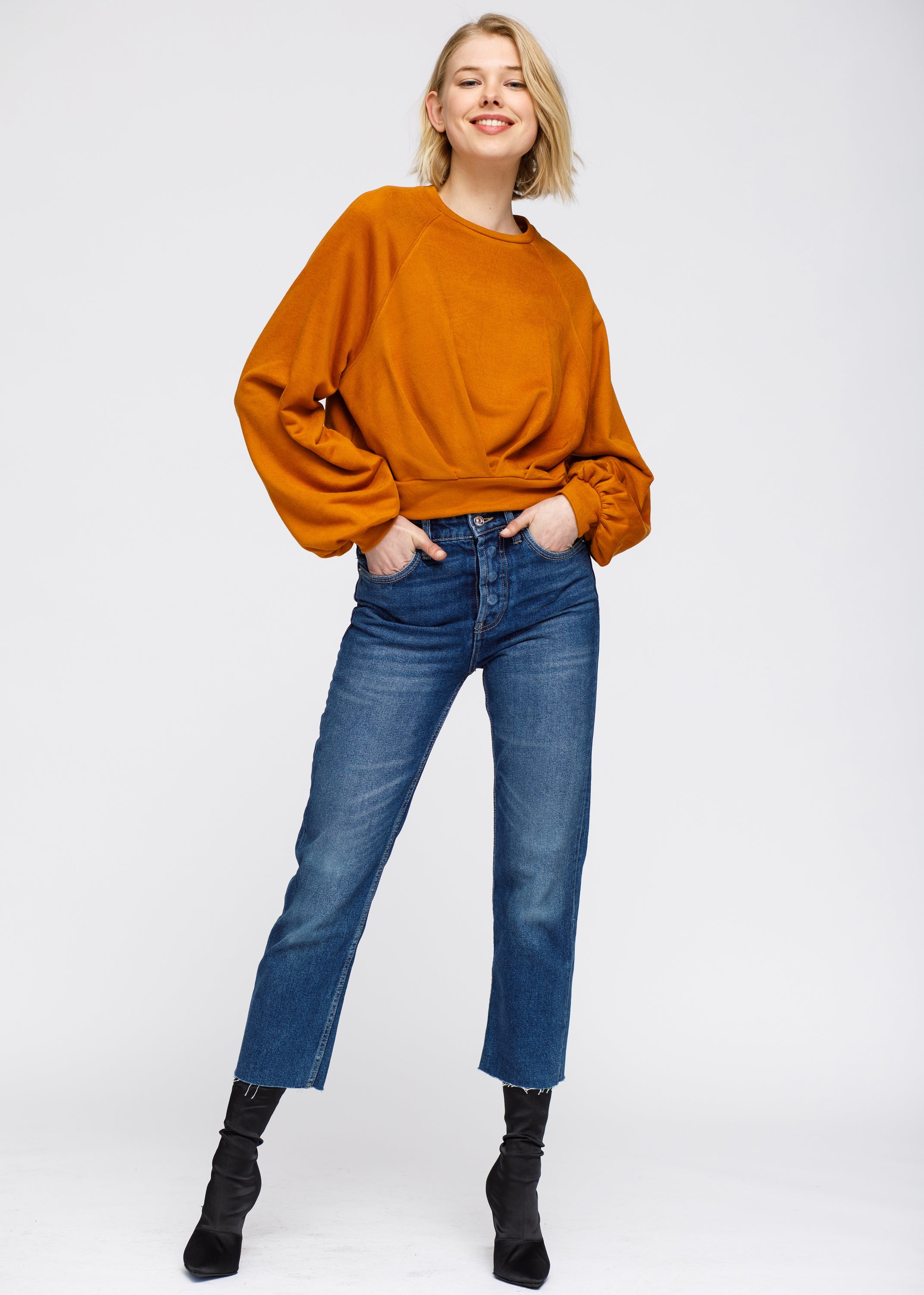 Burnt orange sports hoodie by Start2Finish with front pocket and drawstring hood, shown on a mannequin.