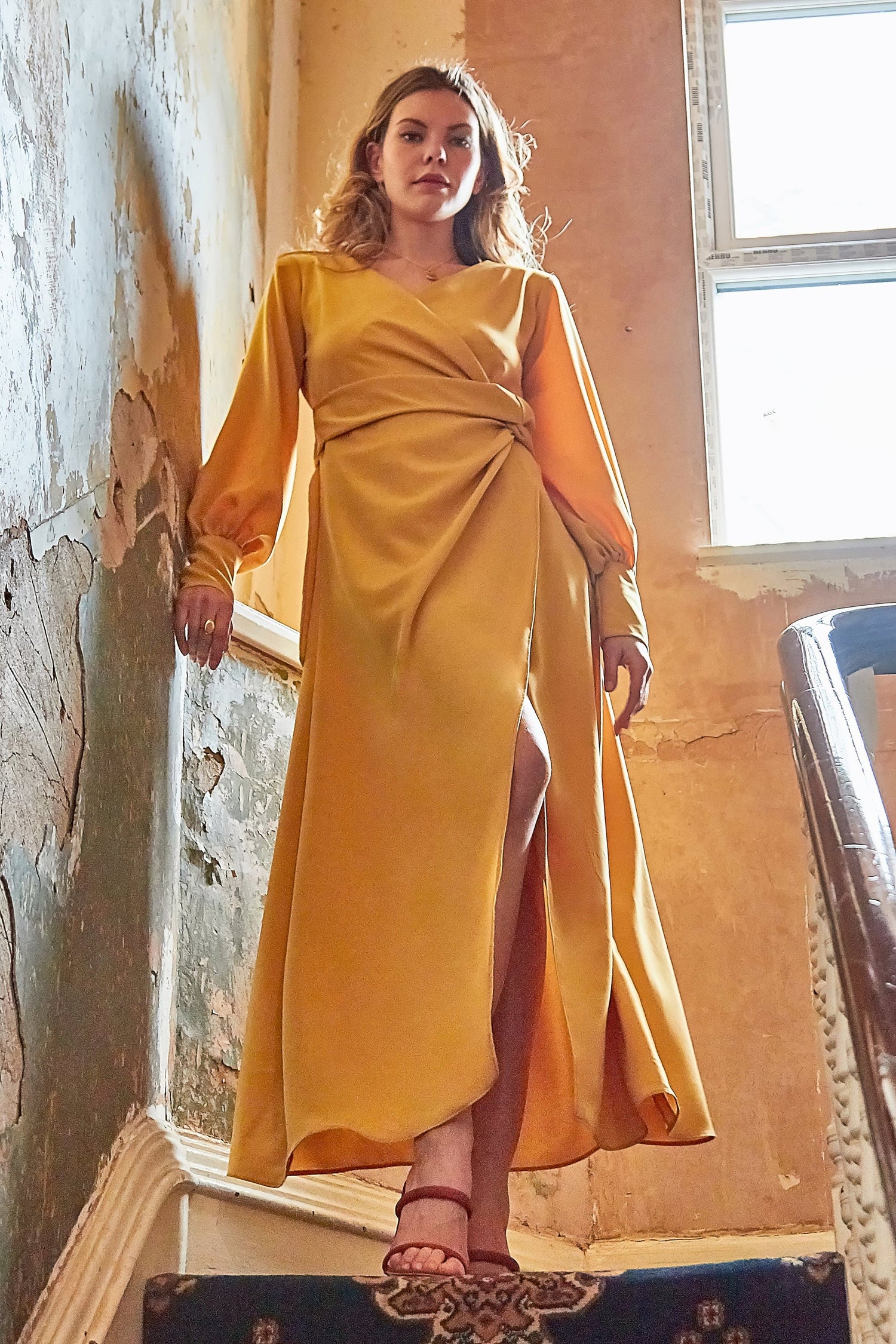 Amber V-neck wrap maxi dress with side slit by Blush Athena, featuring a stylish mustard color and elegant flowing design.