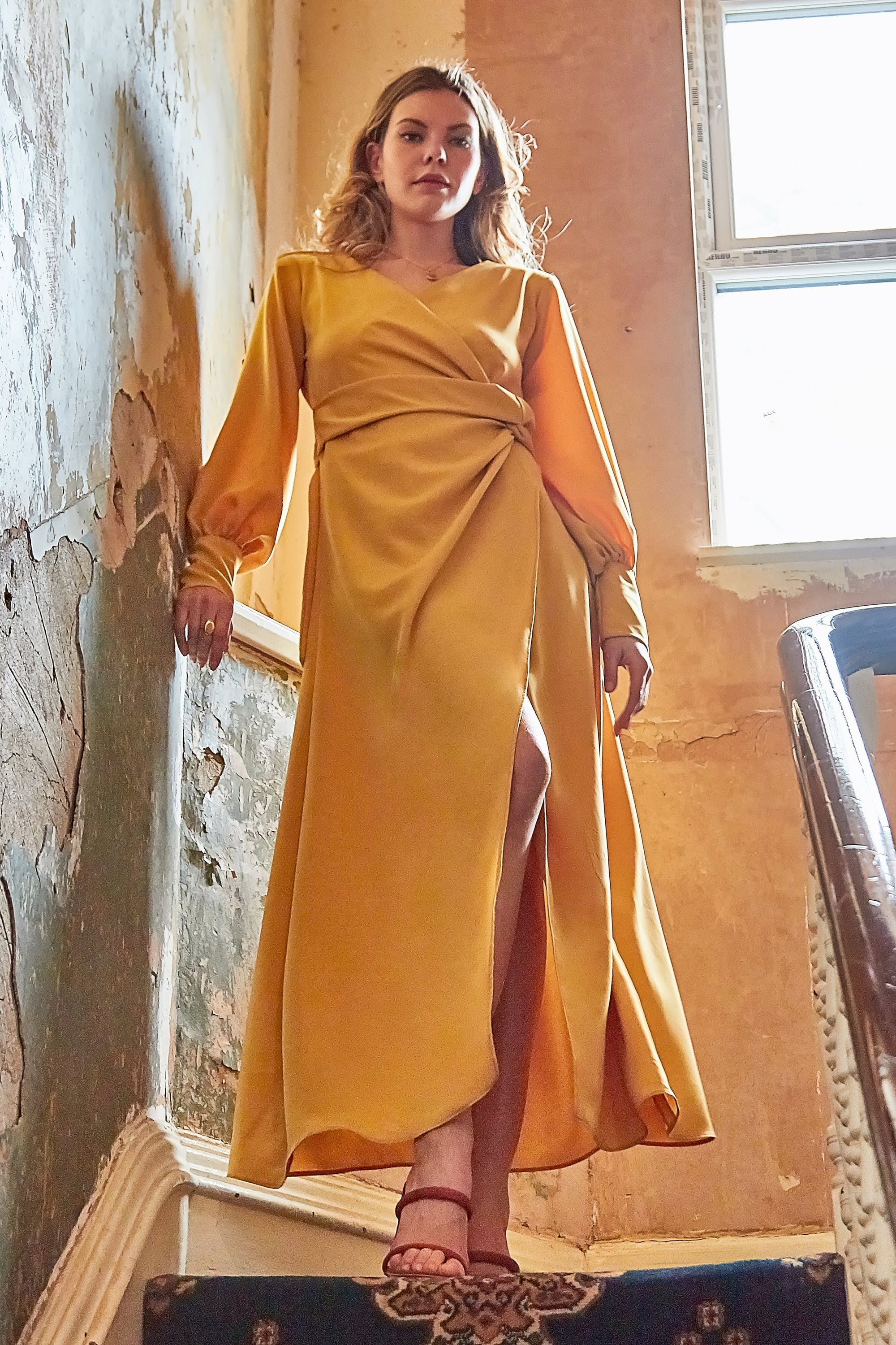 Amber V-neck wrap maxi dress with side slit by Blush Athena, featuring a stylish mustard color and elegant flowing design.