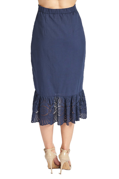 Navy blue Aster skirt by Peach Dionysus featuring cotton eyelet fabric and an asymmetric hi-lo hem, shown from the back.