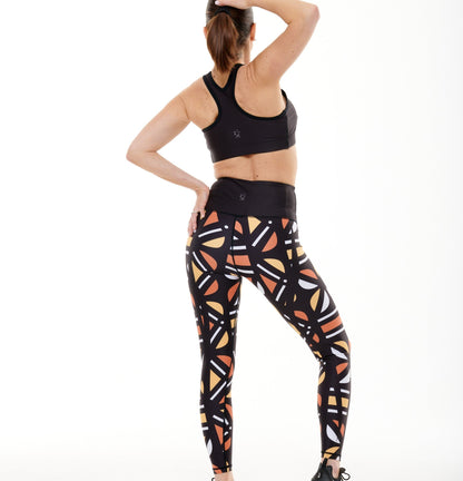 White Oliver Batiq Vibrant Leggings, activewear with colorful geometric patterns, shown from the back.