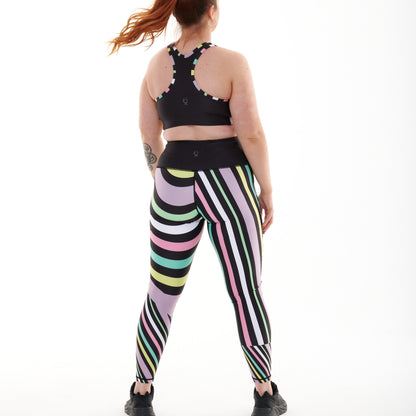 White Oliver Aso-Oke pastel vibrant activewear leggings shown from the back with colorful traditional African fabric design.