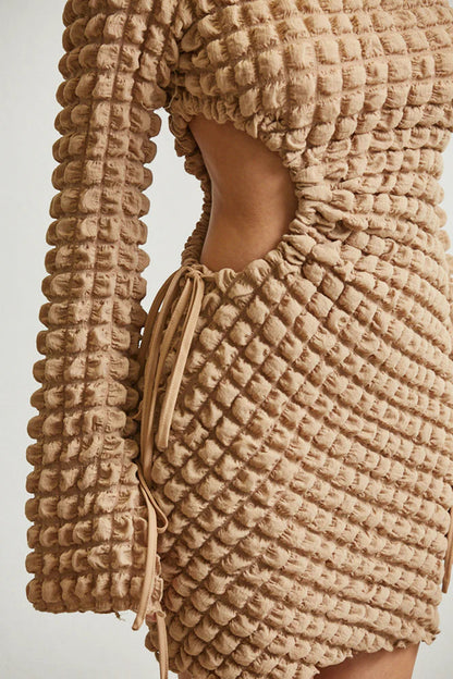 Close-up of White Amphitryon Bell Charm Waffle Dress detail showing textured fabric and bell charm accents for women&