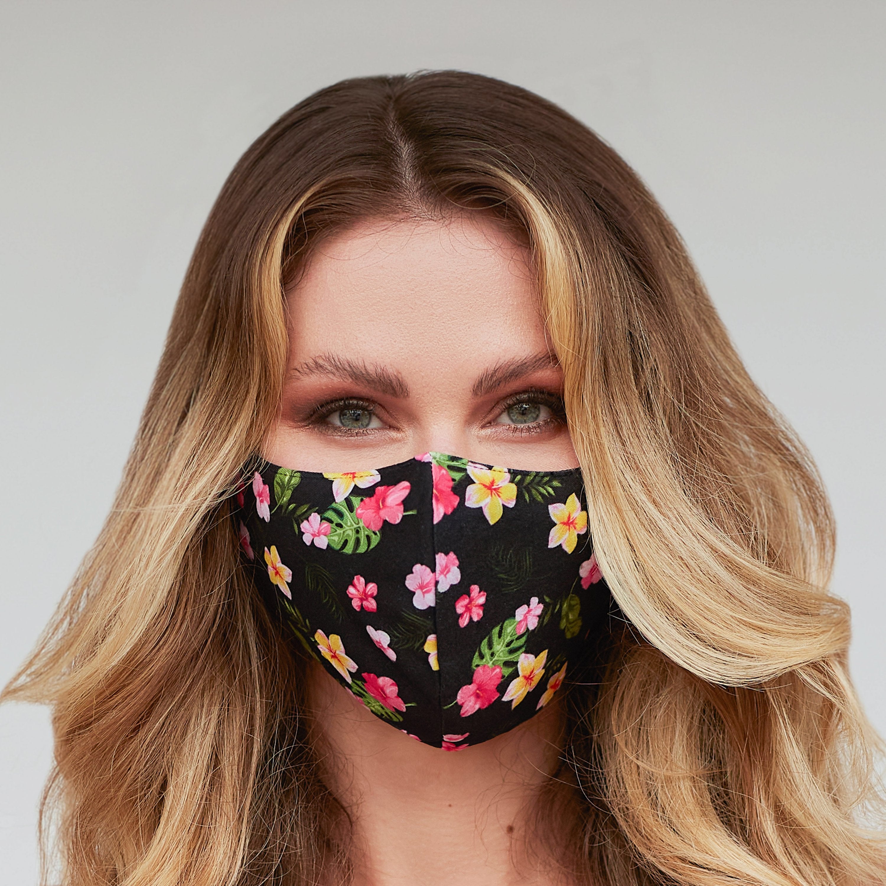 Black floral face mask for women by Cyan Poppy, showcasing a stylish floral pattern on soft fabric.