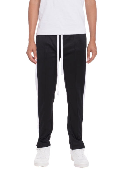 Black Lime Milo striped track pants made of soft tricot fabric, featuring a relaxed fit and sporty style.