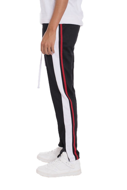 Black striped tricot track pants from Lime Milo with a relaxed fit and elastic waistband, suitable for casual wear.